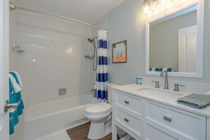 Combined shower/bathtub, hair dryer, towels, soap - Dog Friendly Home w/Private Fenced Yard, Garage & Fire Pit! STEPS to the Beach! (New Smyrna Beach)