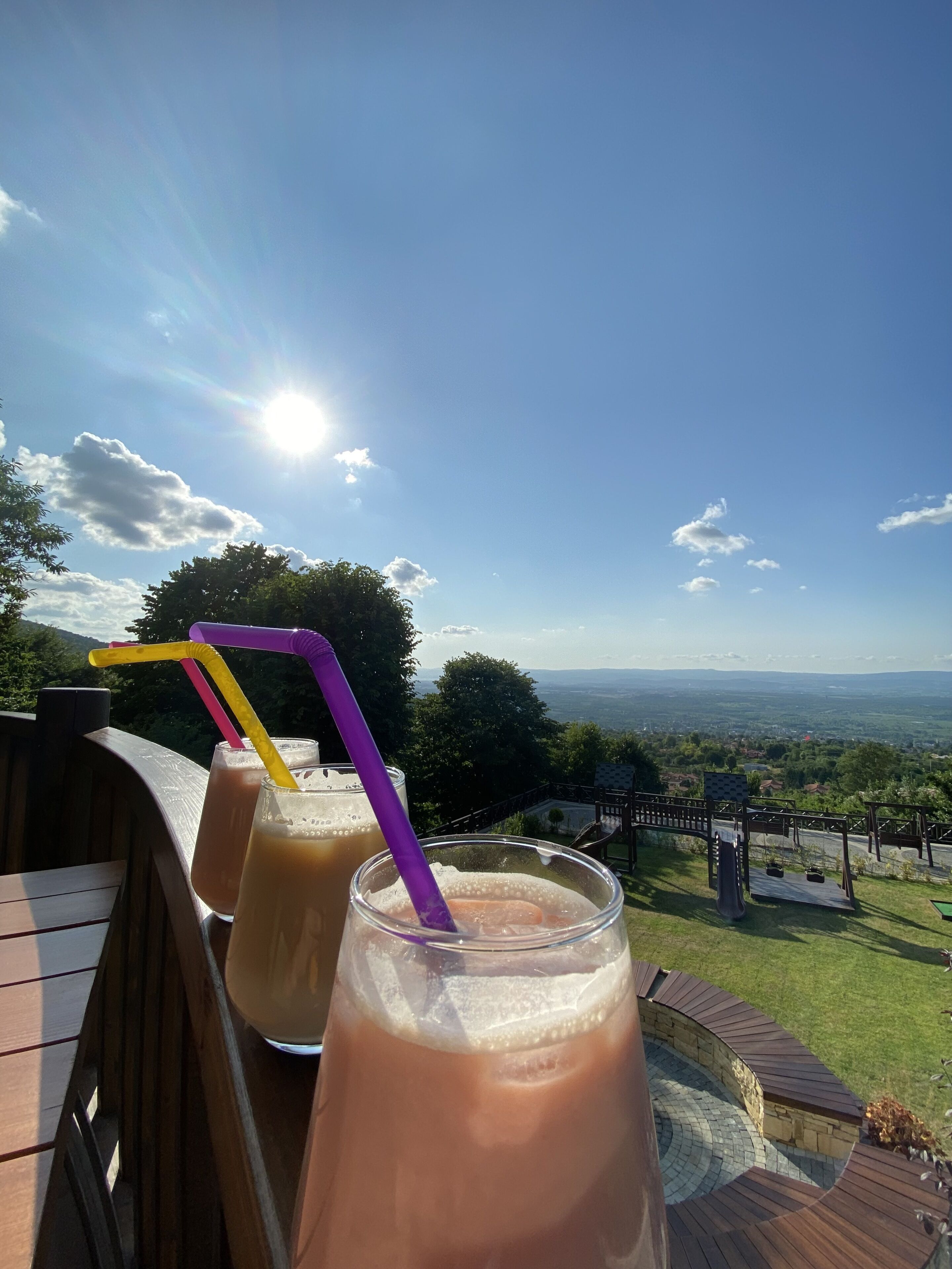 A patio with drinks and a scenic view.