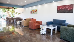A modern lobby with seating arrangements, a coffee table, and artwork on the walls. - Nergos Side Hotel (Manavgat)