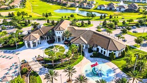 A resort with a central building, a water park, and a golf course.
