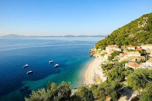 Enjoy a serene beachfront setting with a clear view of the sea from this coastal property.