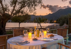 Enjoy a romantic dinner for two with a serene view of the water and mountains.