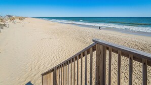 A beach with a wooden walkway leading to the water. - OCTIPI Your SenSEAS - Kitty Hawk, Sea Dunes, Open All Year, Flex Stays, Pool, Clubhouse (Kitty Hawk)