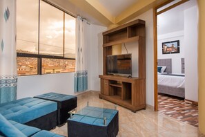 Superior Triple Room | Living area | 20-inch TV with cable channels - Qoripunku villa militar  (Cusco)