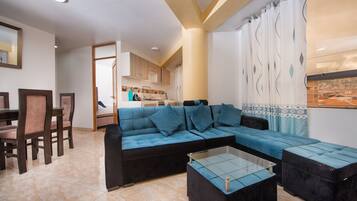 Superior Triple Room | Living area | 20-inch TV with cable channels