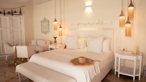 A spacious bedroom with a large bed, bedside tables, and a wardrobe. -  Casa DiLuca Cartagena Hotel Boutique (Cartagena)
