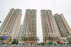 High-rise apartment building with a grid-like pattern of windows and balconies.