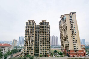 A high-rise residential building with multiple balconies, a flat roof, and a uniform facade. - Kaisheng Express Hotel (Beihai)