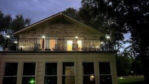 A two-story building with a balcony and multiple windows. - Clair de Lune, Lake Front on Lake Palestine  (Chandler)