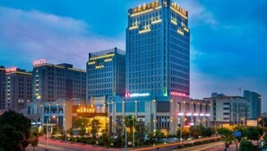 A high-rise building with illuminated signage and a modern architectural design. - Lanxin Hotel (Shaoxing)