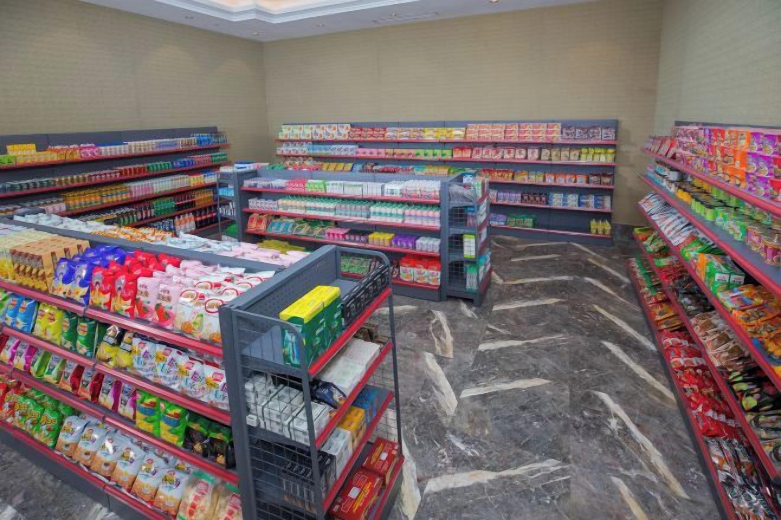 A grocery store aisle with shelves stocked with various products.