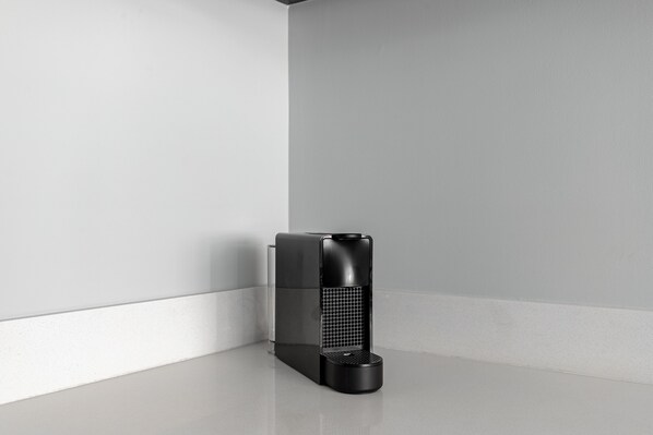 A corner of a room with a black heater against a white wall and floor. - Lumina at Cardinal Cabo San Lucas (Cabo San Lucas)