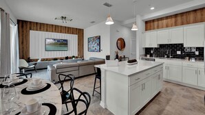 A modern kitchen with white cabinets, a central island, and pendant lighting. - 2 Bedrooms/ 2 Bathrooms/ Storey Lake (3191-405 PC) (Kissimmee)