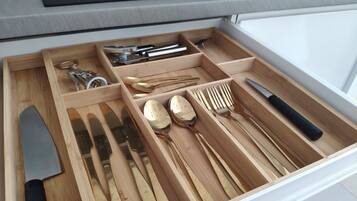 A kitchen drawer with utensils and cookware.