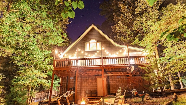 A cabin with a covered porch, a fire pit, and outdoor seating. - Canopy Ridge Retreat Cabin, couples oasis. Nature weddings (Sevierville)