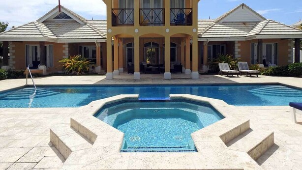 A two-story building with a swimming pool in front. - "Atlantique" is a seaside space to be remembered! (Lowlands)