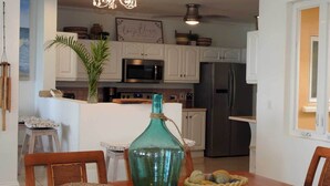 A modern kitchen with white cabinets, stainless steel appliances, and a central island. - "Atlantique" is a seaside space to be remembered! (Lowlands)