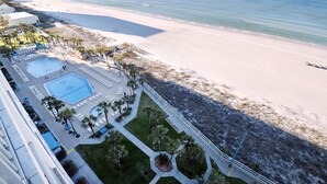 A resort with a pool area, a beach, and a view of the ocean. - Beachside Escape: Pool, Balcony, Free Chairs & More (Panama City Beach)