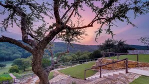 A tree-lined pathway with stone steps and a railing, leading to a grassy area with a view of distant hills. - Austin Guitar Pool | 87.5 FT Guitar Pool (Austin)