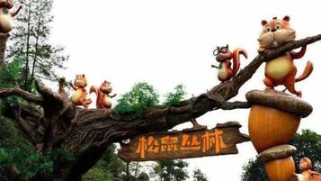 A tree with a sign and animated characters.