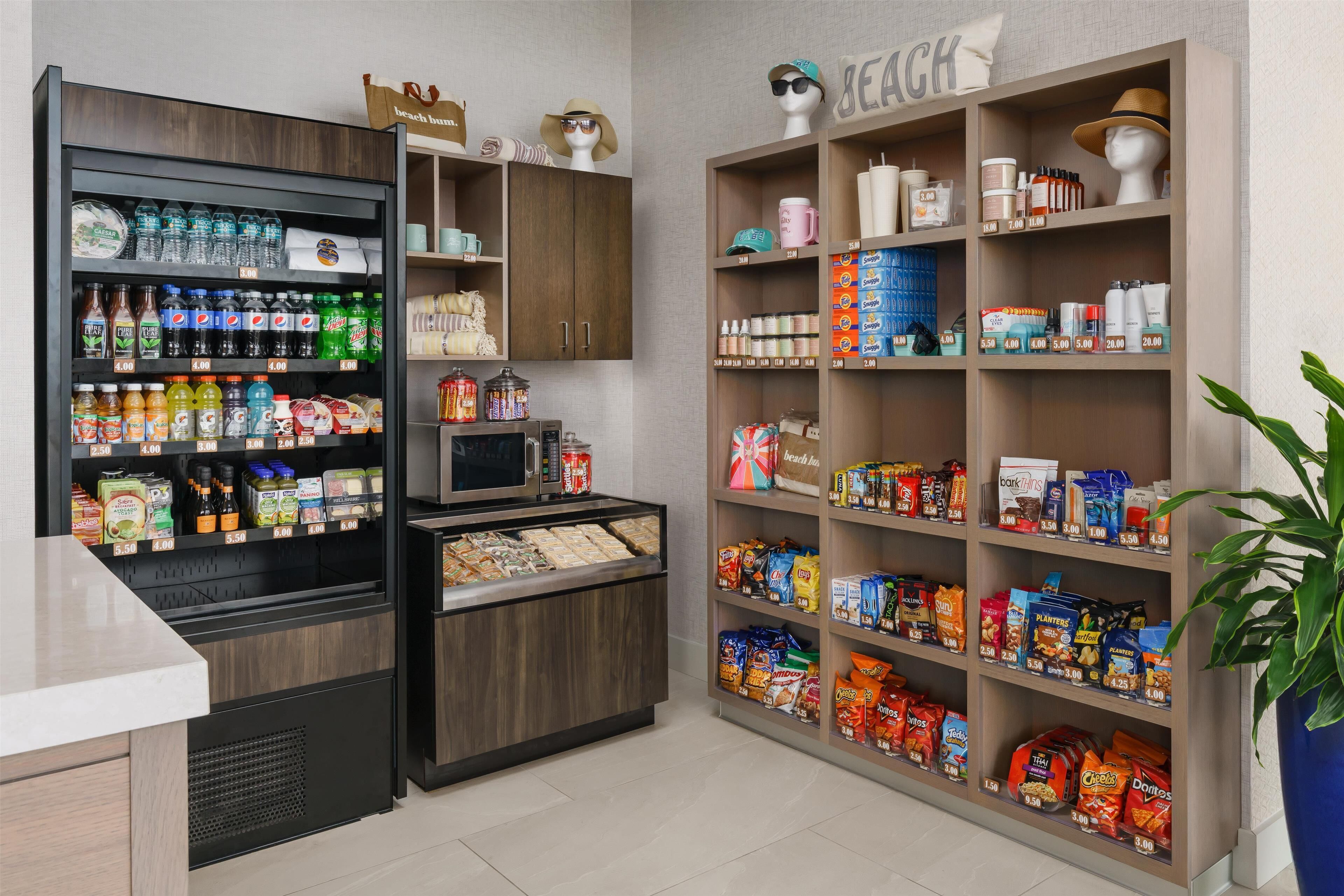 A grocery store with shelves stocked with snacks, beverages, and household items.