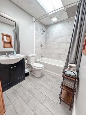 Combined shower/bathtub, hair dryer, towels, toilet paper