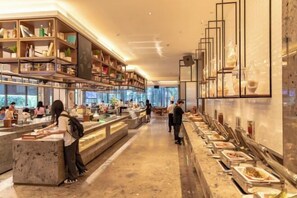 A modern buffet setup with multiple food stations and a well-organized layout. - Nanan Hotel (Nan'an)