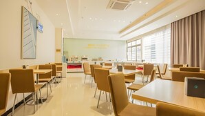 A modern conference room with tables and chairs, a reception desk, and a large window with curtains. - City Comfort Inn (Liuzhou)