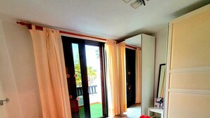 A bedroom with a bed, a wardrobe, and a sliding glass door leading to a balcony. - Parque Santiago 2. 2 bedroom 3 bathroom duplex. (Arona)