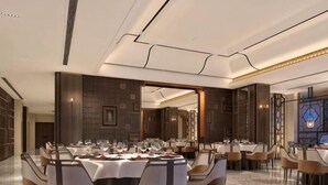 A formal dining room with a long table set for multiple guests, surrounded by chairs. - Jindu Hotel (Gucheng)