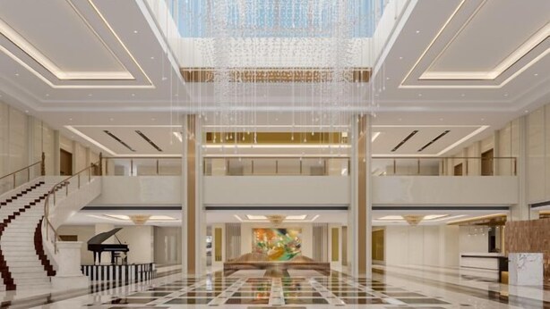 A spacious lobby with a grand piano, a large abstract painting, and a high ceiling with a chandelier. - Jindu Hotel (Gucheng)