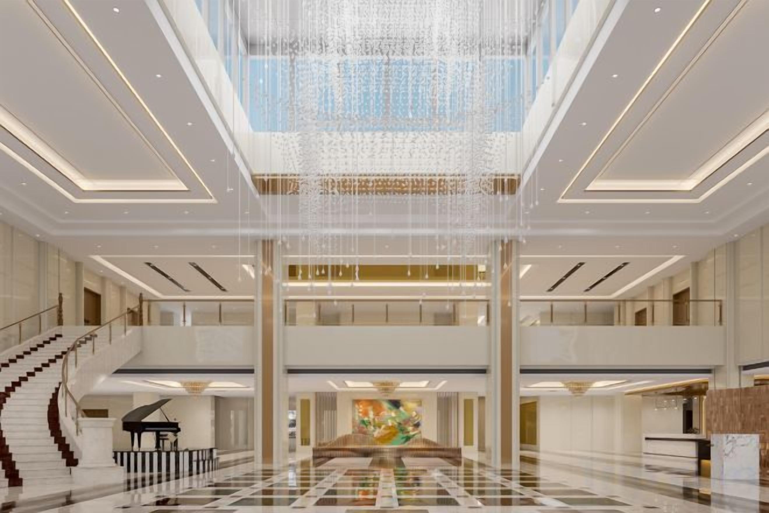 Un hall d’entrée spacieux, agrémenté d’un magnifique escalier, d’un piano et d’un grand lustre.