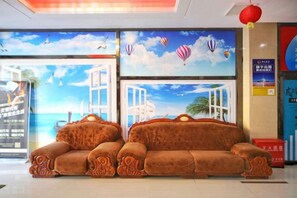 A hotel lobby with a large window, a brown sofa, and a red lantern. - Yading Hotel (Yicheng Xiangsha Avenue) (Yicheng)