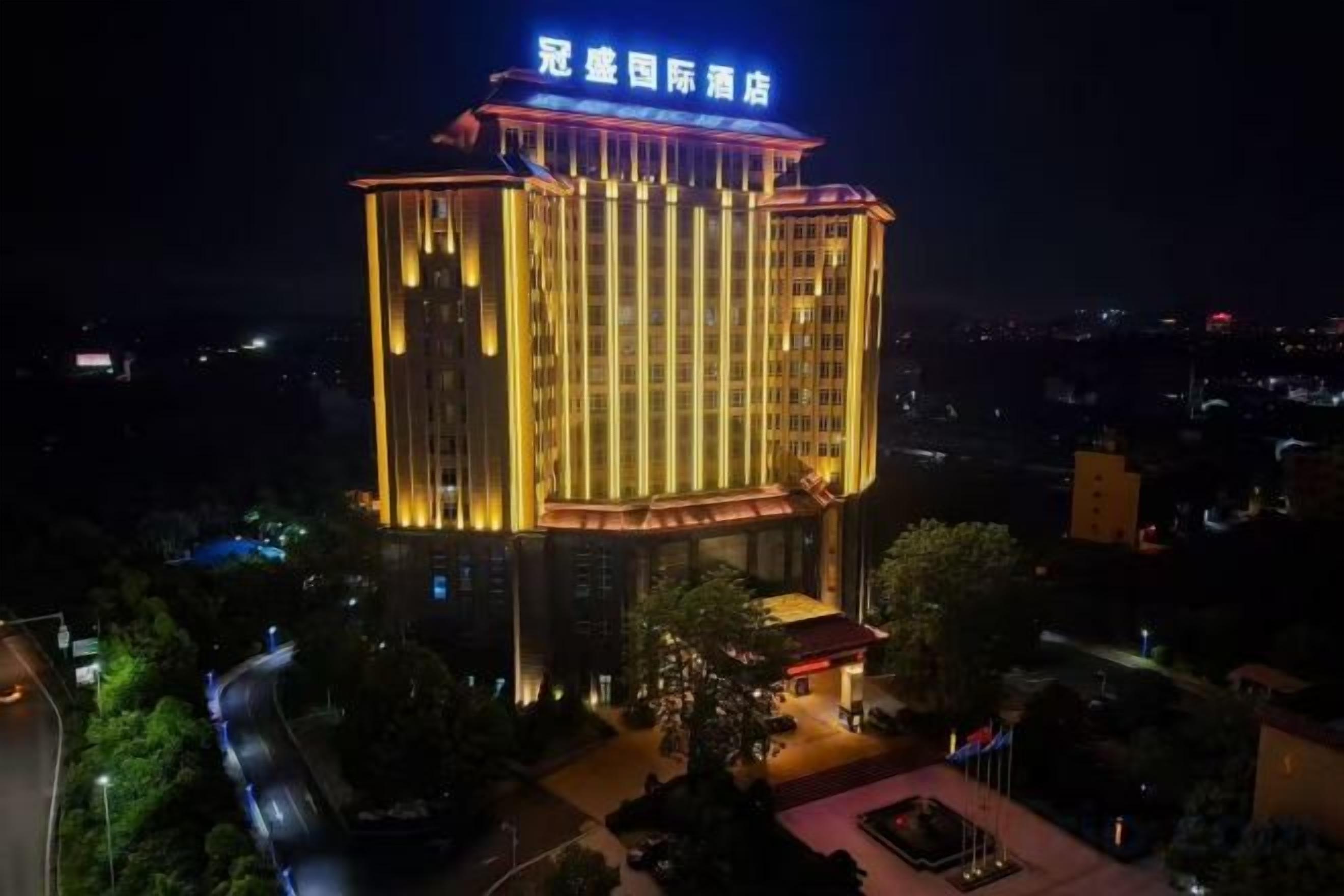 A multi-story hotel with a prominent sign at the top.