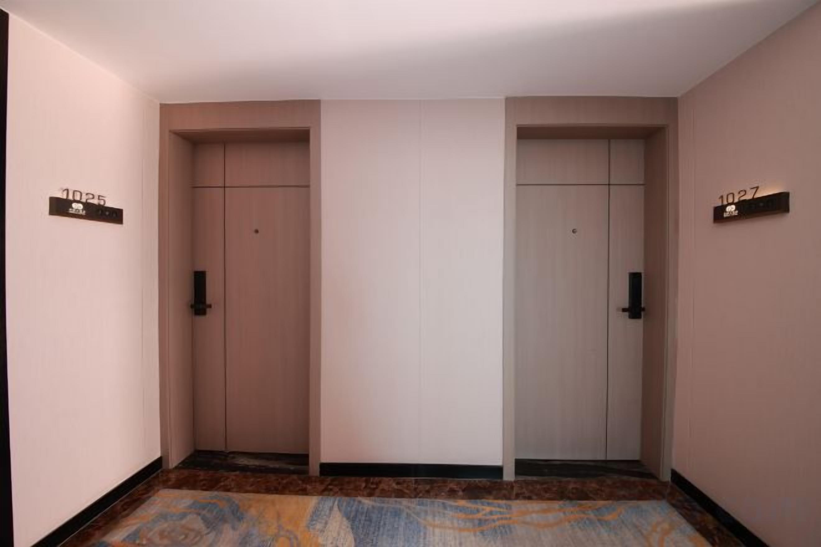 A hallway with two doors, each marked with a number.