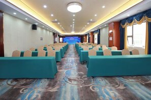A conference room with rows of chairs, a carpeted floor, and a stage at the front. - Shenzhen Bolang Hotel (Xintangwei Metro Station) (Shenzhen)