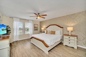 A bedroom with a bed, nightstands, a ceiling fan, a TV, and a window with curtains. - Private Conservation View With Theme Rooms and Beautiful Pool Area, Perfect for Families #5st4591 (Davenport)