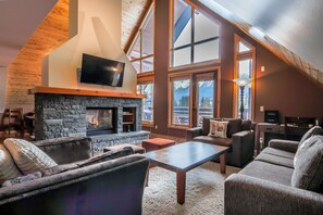 R401 Two Bedroom Elevated Condo | Living area | 50-inch Smart TV with cable channels, TV, fireplace - Spring Creek Vacations (Canmore)