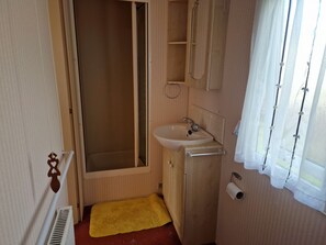 A compact bathroom with a shower, sink, and toilet. - No Longer Available to let (Welshpool)
