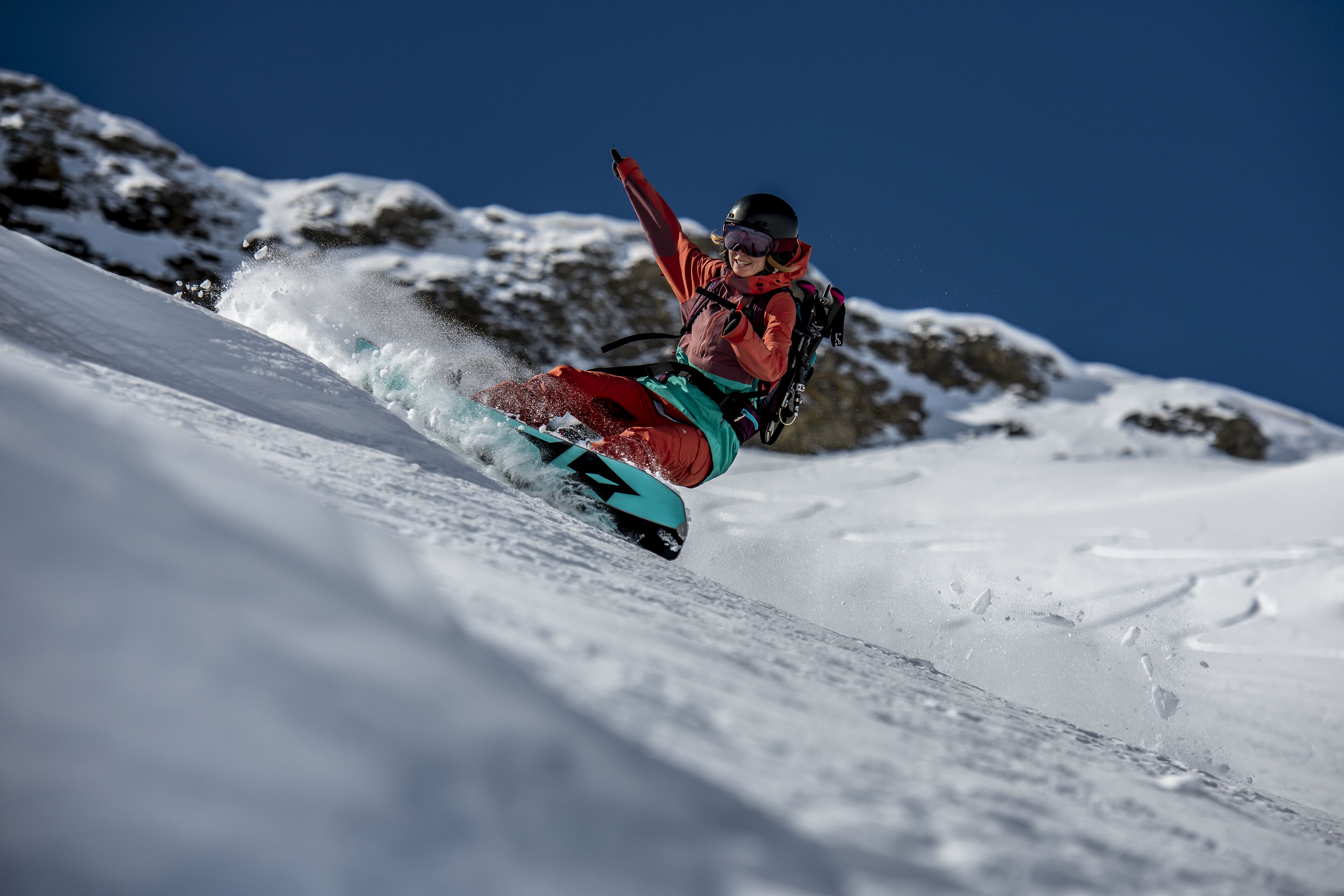 A snowboarder in motion on a snowy slope.