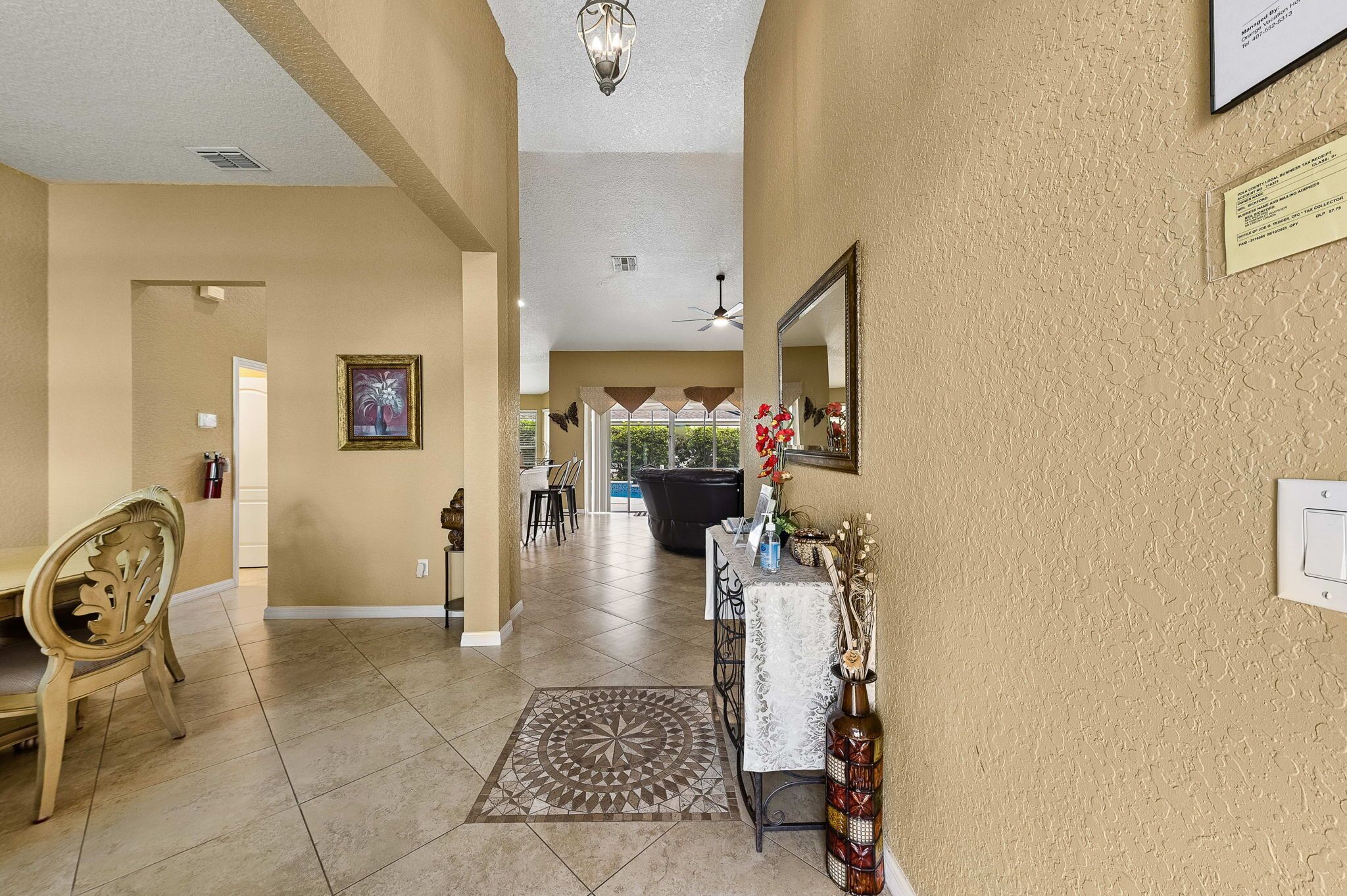 A hotel lobby with a reception desk, a dining area, and a view of the outdoors.