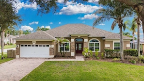 A single-story house with a garage, a front door, and a driveway.