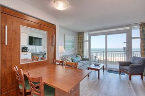 Enjoy a spacious room with a dining area, seating area, and kitchenette, offering a view of the beach.