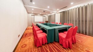 A conference room with a long table, red chairs, and a carpeted floor. - Jingyue Boutique Hotel (Linyi Olympic Sports Center Store) (Linyi)