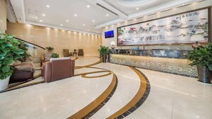 A modern lobby with a curved reception desk, seating area, and a large wall painting. - Yifeng Hotel (Wenli College Honghe Campus Store) (Chongqing)