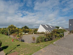 Guests can enjoy a serene outdoor setting with a grassy area and pathway leading to a modern building.
