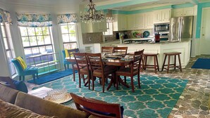 A spacious living room with a large sofa and a dining area with wooden chairs and a table. - Waterfront, Boat Dock, Great Fishing - Long Term Renters Welcome - Sleeps 9 (Trinity)