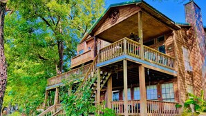 A wooden cabin with a balcony, a staircase, and a chimney. - Waterfront, Boat Dock, Great Fishing - Long Term Renters Welcome - Sleeps 9 (Trinity)