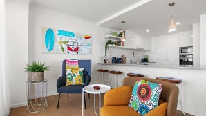 A compact living space with a kitchenette, a dining area, and a seating area.