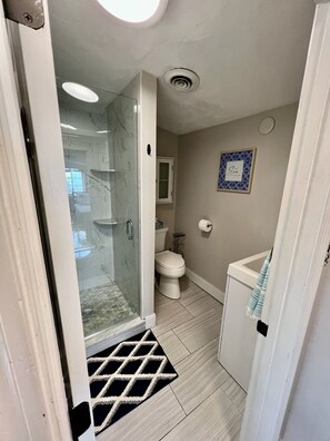 Shower, towels, soap, toilet paper